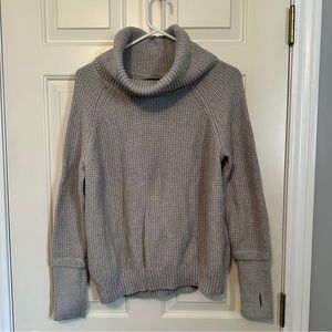 Knit sweater with thumb holes